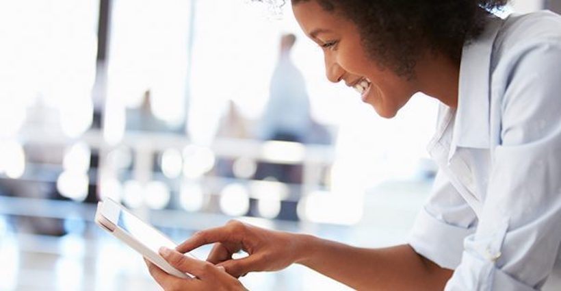 Woman engaging with content on tablet.